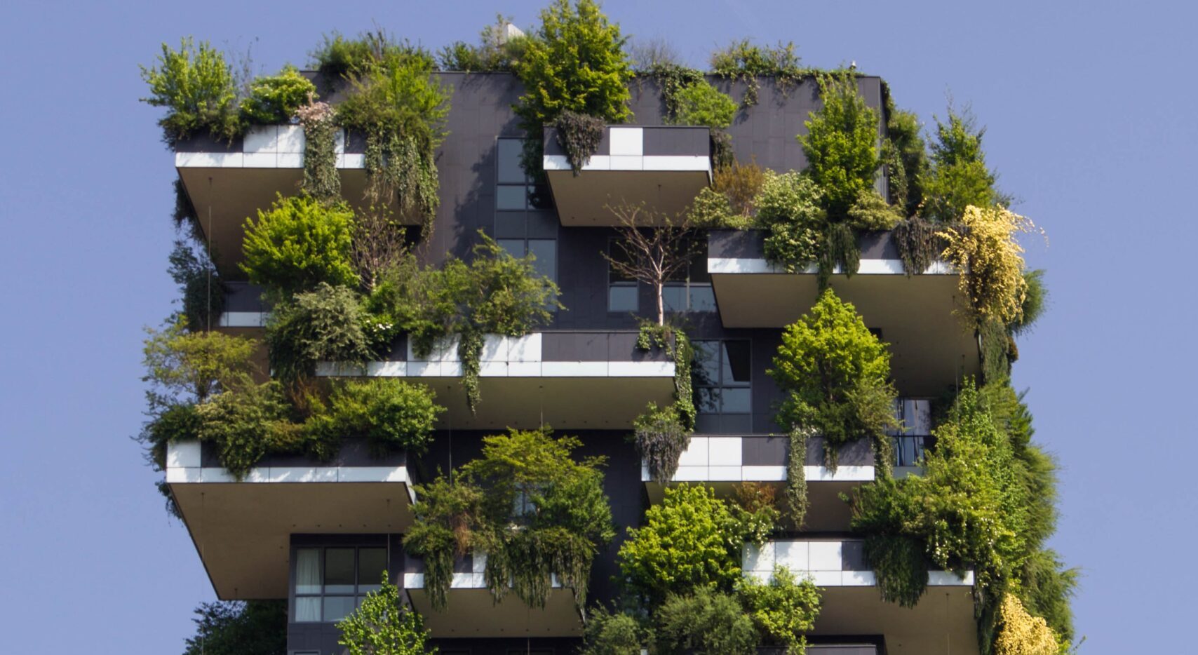 High-rise building Bosco Verticale with lush trees growing on balconies in Milan, Italy