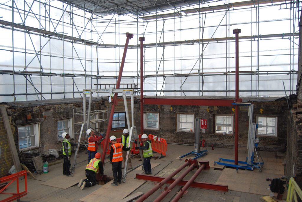 A wide shot of some engineers installing a new mansard roof on the Cannon Street Aparthotel London project